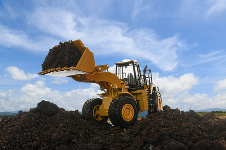 Wheel loader are digging the soil in the construction site on the blue sky  background