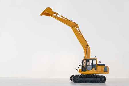 Yellow excavator   model  on  a white background,With bucket lift upの写真素材