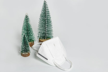 Christmas tree with mask KN95 on white background,The concept health care
