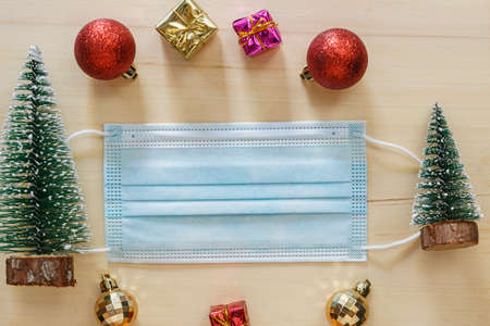 Medical mask and decoration on the floor wooden background ,Concept health care in Christmas festivalの写真素材