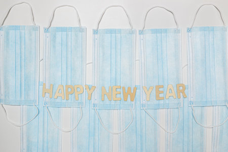 Happy new year on  medical  masks  with white background.