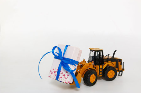 Gift box with  wheel loader model lift up.  Festival holiday celebration concept