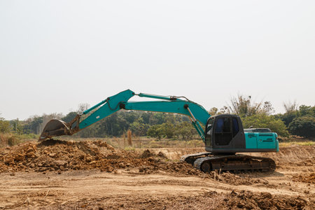 Cyan Excavators are digging the soil in the construction site location fieldの写真素材