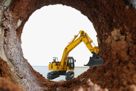 Crawler excavator are digging soil in the tunnel construction site.の写真素材
