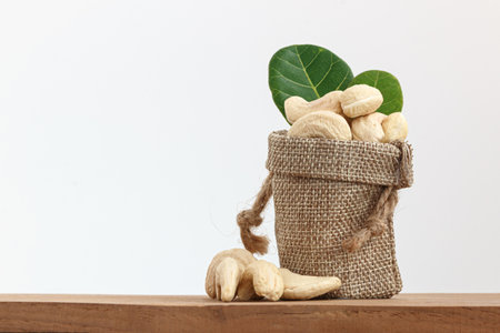 Cashew nuts raw with green leaf in bagの写真素材