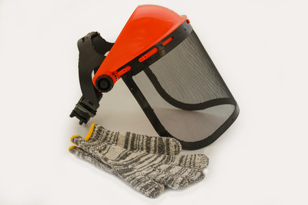 Lawn Mower Flakes Protection Mask and cloth gloves on a white  background