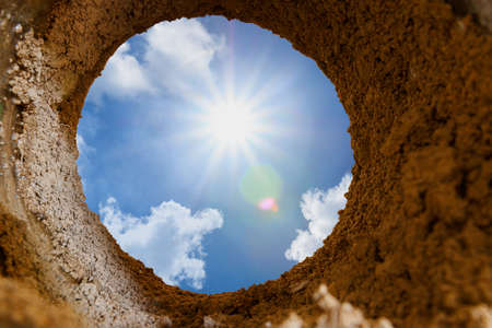 Sunbeam of light from the sun with blue sky,concept of light at the end of the tunnelの写真素材