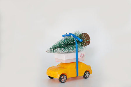 Christmas tree with the gift tie on toy yellow car. Christmas  festival holiday celebration conceptの写真素材