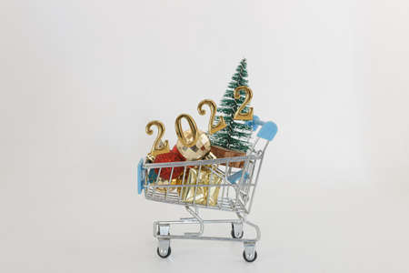 Happy new year concept 2022,christmas tree and ball in a shopping trolley  on white backgroundの写真素材