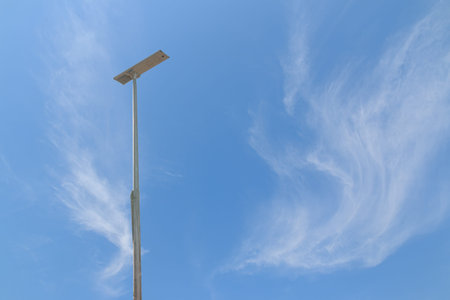 Solar cell street lamp pole with thin white clouds sky background