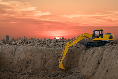 Crawler excavators are digging the soil in the construction site city on  sunset backgroundの写真素材