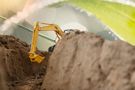 Selective focus ,Excavator with Bucket  are digging  soil in the construction site on the  environment eco backgroundの写真素材