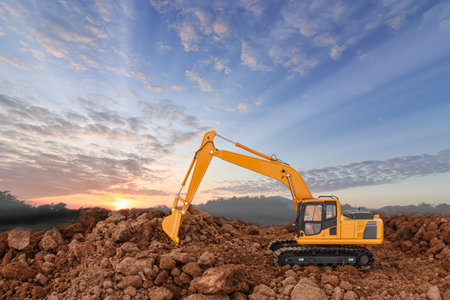 Excavators  are digging soil with  in the construction site on sunset background