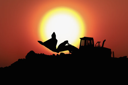 Wheel loader silhouette are digging soil with bucket lift up in the construction site on  sun...