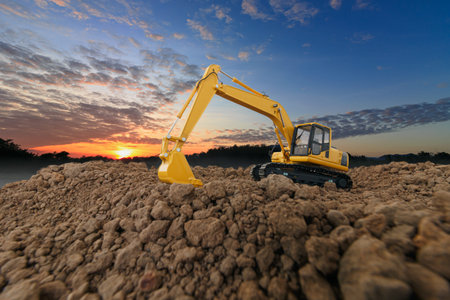 Excavators  are digging soil with  in the construction site on sky  with sunset background