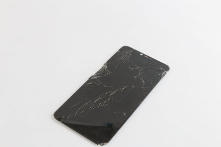 Broken old smartphone screen on white background