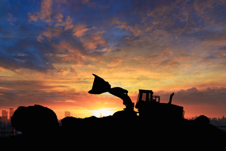 Wheel loader  silhouette are digging the soil in the construction site.With on  cloud and sky  background.の写真素材