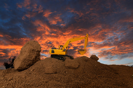 Crawler excavator is digging soil in the construction site   with sunset  backgrounds.