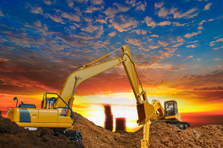 Crawler excavator with Bucket lift up are digging the soil in the construction site on the sunset sky backgroundsの写真素材