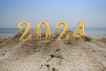 Happy New Year 2024  concept image with text  on  floors sand beach with sea backgroundの写真素材