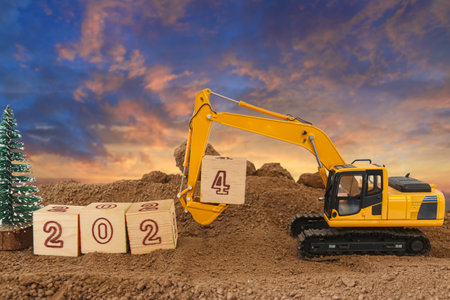 Concept Happy new year 2024,crawler excavator in construction site .on sunrise backgroundsの写真素材