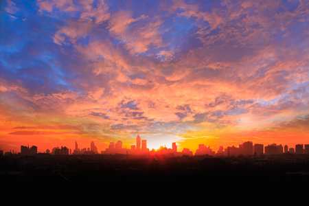 Background of orange sky with clouds and sunset in  city.の写真素材