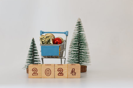 Christmas decoration in a shopping trolley on a white backgrounds,With Happy new year concepts 2024