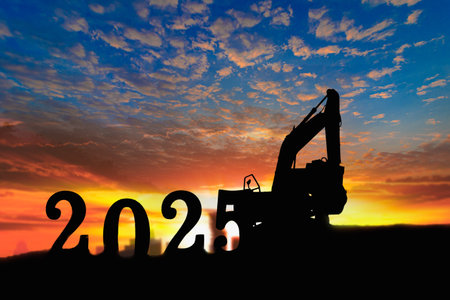 Concept happy new year 2025,crawler excavator silhouette with lift up bucket .On sunrise backgroundsの写真素材