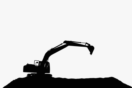 Crawler excavators silhouette are digging the soil in the construction site ,With bucket lift up on the white backgroundの写真素材