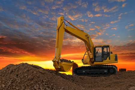 Crawler excavator with are digging the soil in the construction site with blue sky and orange fluffy...