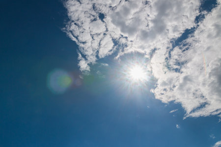 Blue sky background with sunlight  and white cloudの写真素材