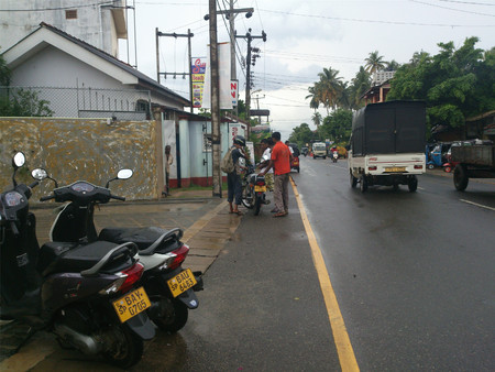 Pedestrians helping the motorcyclist on the roadのeditorial素材