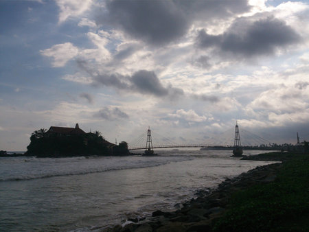 Silhouette view of a bridge leading to a small islandの写真素材