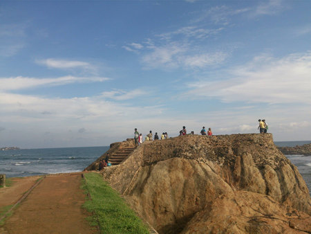 People gathering by a seashoreの写真素材