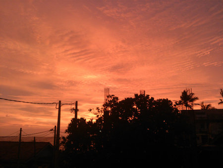 Sun setting in a townの写真素材