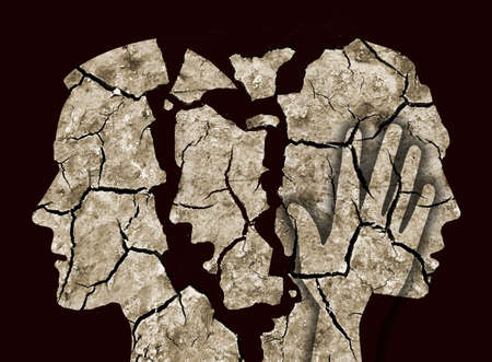Schizophrenia, depression male head silhouettes. Male head silhouettes. Photo-montage with Dry cracked earth.The image does not show real people. Concept psychiatric problems.の写真素材