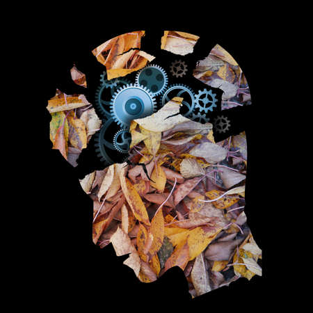 Dementia, depression, autumn, depressed man. Stylized male head silhouette. Photo-montage with autumn leaves and gears symbolizing psychological problems.の写真素材