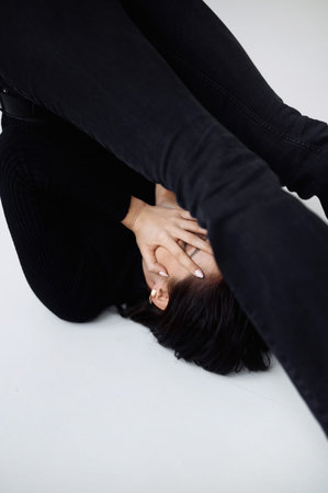 Good series of photos of young pretty woman. studio. European type, big lips, awesome eyes, slim body. white background. black clothes. Emotional. minimalism. style. fashionable and modern lifestyleの写真素材