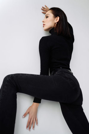 Good series of photos of young pretty woman. studio. European type, big lips, awesome eyes, slim body. white background. black clothes. Emotional. minimalism. style. fashionable and modern lifestyleの写真素材