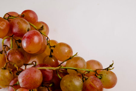 Fresh and healthy lucky grapes with space for text on white background