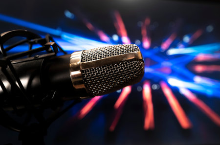 Microphone with pedestal in party atmosphere with background of lights and colorの写真素材