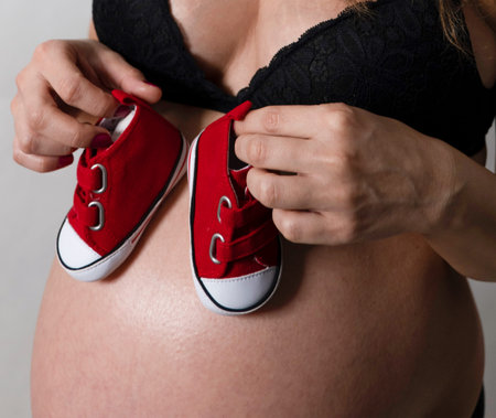 Scene on black background of belly in advanced state of gestation, young woman 9 months pregnant...