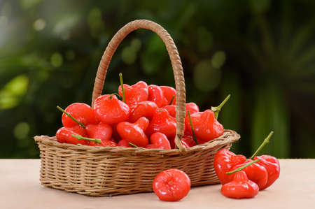 Wicker basket filled with red fruitsの写真素材