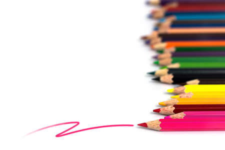 Pink line with colorful pencils that placed in a long row, isolated on white backgroundの写真素材