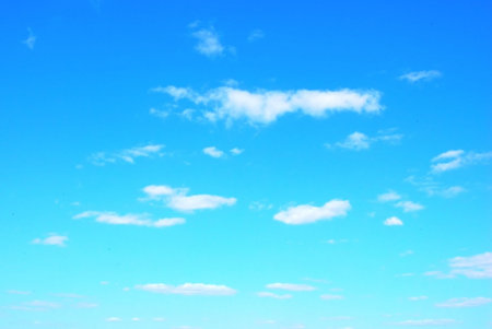 fluffy clouds over blue sky