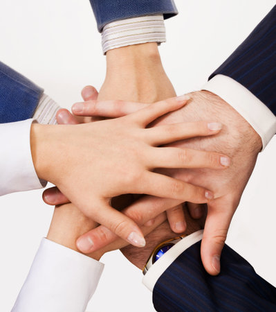Close-up. Six human hands one on another. View is from the top