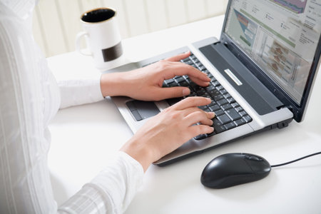 Female hands typing a letter on the laptop