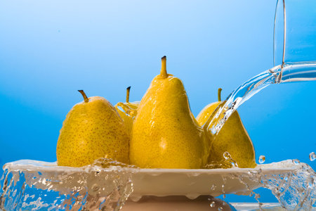 Water pouring on yellow pears.の写真素材