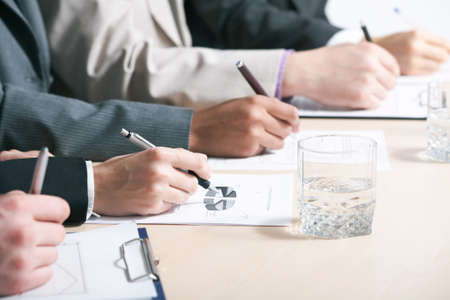 Close-up of business person hand working with document 

の写真素材