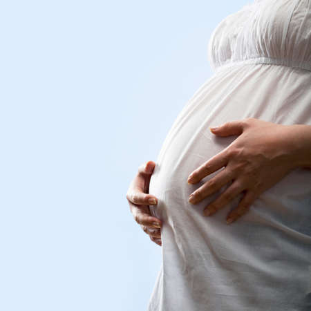Image of pregnant woman touching her belly with hands 
の写真素材